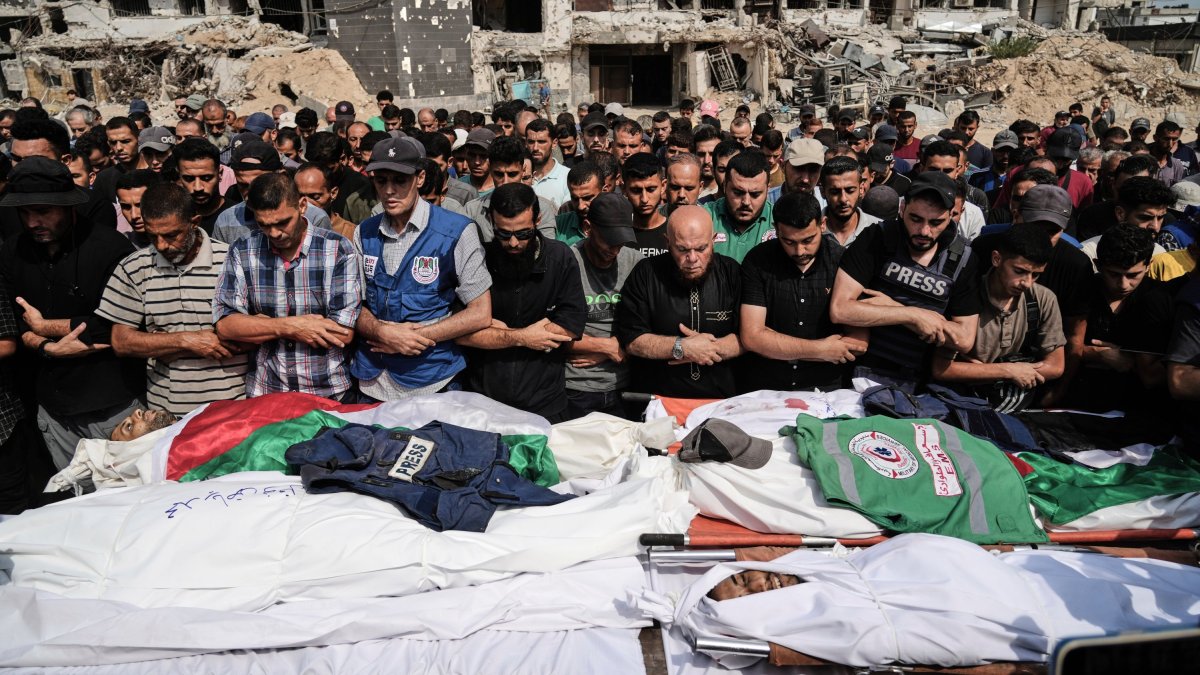 Palestinians pray over the bodies of journalists, including Al Jazeera correspondents Anas al-Sharif and Mohamed Qreiqeh, who were killed in an Israeli airstrike, during their funeral outside Shifa hospital complex, Gaza City, Palestine, Aug. 11, 2025. (AP Photo)