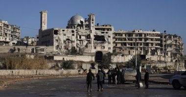 People gather near damaged buildings at the Sheikh Maksoud neighbourhood after general security forces took control of the area, following the collapse of an agreement between the Syrian government and the PKK/YPG terrorist group, in Aleppo, Syria, Jan. 10, 2026. (Reuters Photo)