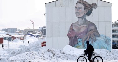 A man passes a building with social housing with an Inuit mural in Nuuk, Greenland, March 27, 2025. (Reuters Photo)