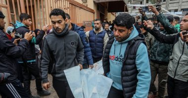 Palestinians carry the bodies of four people, including two children, killed in Israeli air strikes in Mawasi district of Khan Younis, the Gaza Strip, JAn. 9, 2026. (AA Photo)