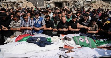 Palestinians pray over the bodies of journalists, including Al Jazeera correspondents Anas al-Sharif and Mohamed Qreiqeh, who were killed in an Israeli airstrike, during their funeral outside Shifa hospital complex, Gaza City, Palestine, Aug. 11, 2025. (AP Photo)