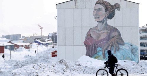 A man passes a building with social housing with an Inuit mural in Nuuk, Greenland, March 27, 2025. (Reuters Photo)