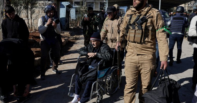 A man is assisted as he evacuates from Sheikh Maksoud neighbourhood following the collapse of an agreement between the Syrian government and the PKK/YPG terrorists, in Aleppo, Syria, Jan. 10, 2026. (Reuters Photo)