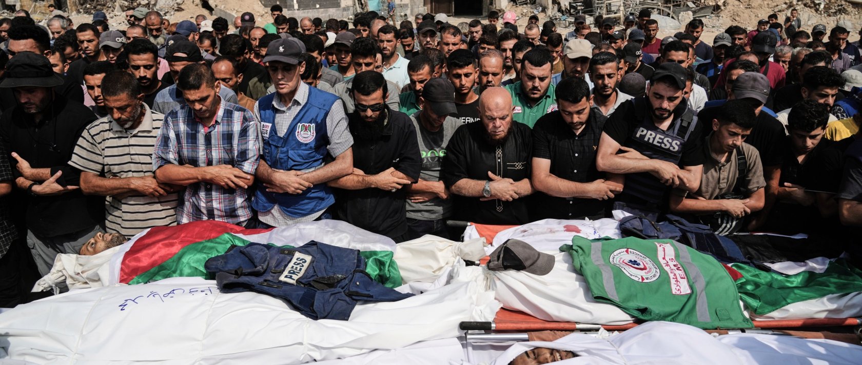 Palestinians pray over the bodies of journalists, including Al Jazeera correspondents Anas al-Sharif and Mohamed Qreiqeh, who were killed in an Israeli airstrike, during their funeral outside Shifa hospital complex, Gaza City, Palestine, Aug. 11, 2025. (AP Photo)
