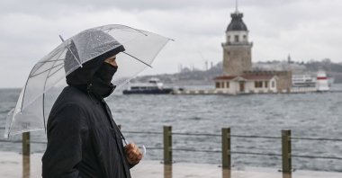 A man walks along the shore during a rainstorm in Üsküdar district, Istanbul, Türkiye, Jan. 11, 2026. (AA Photo)