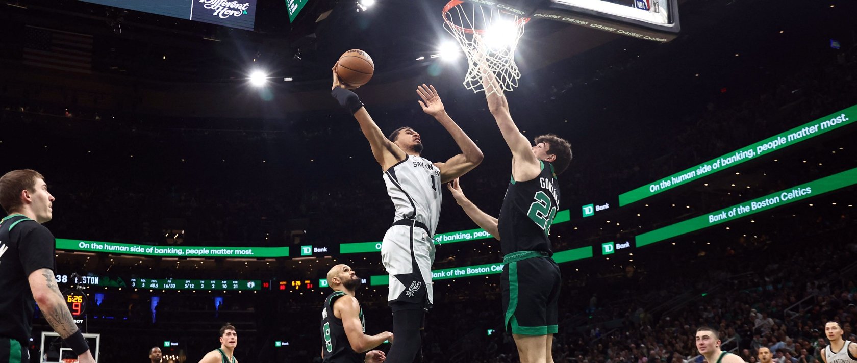 Spurs' Victor Wembanyama (L) goes in to dunk over Celtics' Hugo Gonzalez during an NBA game, in Boston, Massachusetts, U.S., Jan. 10, 2026. (AFP Photo)