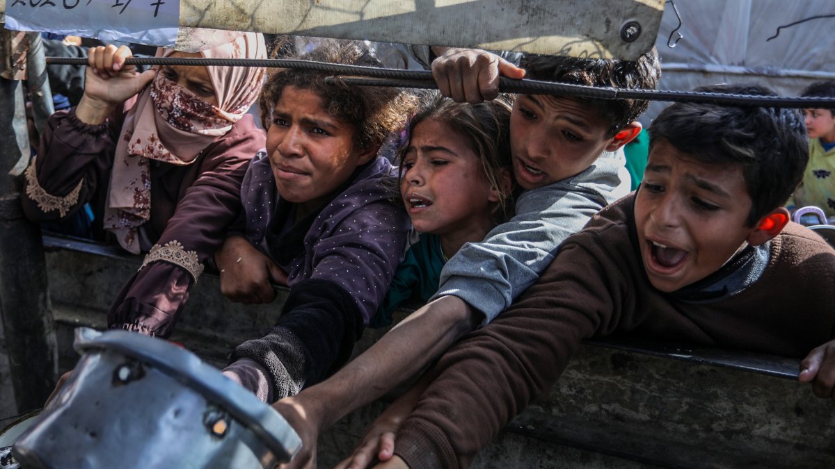 Palestinians, mainly children, wait to get hot food distributed by a charity organization at the al-Mawasi district, Khan Yunis, Gaza, Palestine, Jan. 7, 2026. (AA Photo)