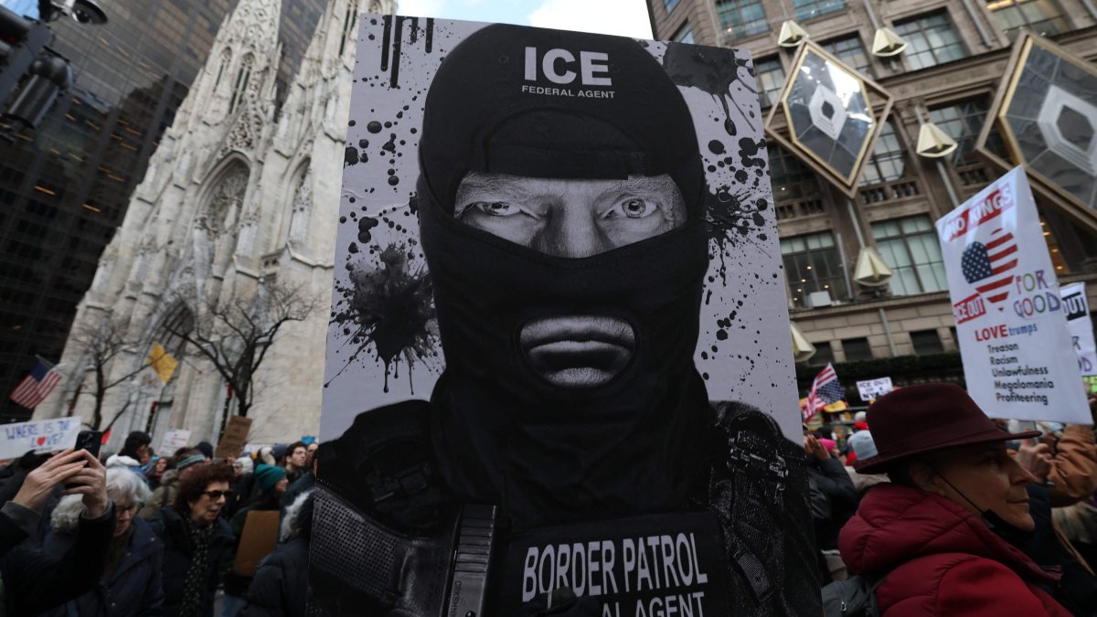 A protester holds a sign depicting Donald Trump as an ICE agent during a demonstration organized by Rise and Resist against US Immigration and Customs Enforcement (ICE) activities and the U.S. intervention in Venezuela, New York, U.S., Jan. 11, 2026. (AFP Photo)
