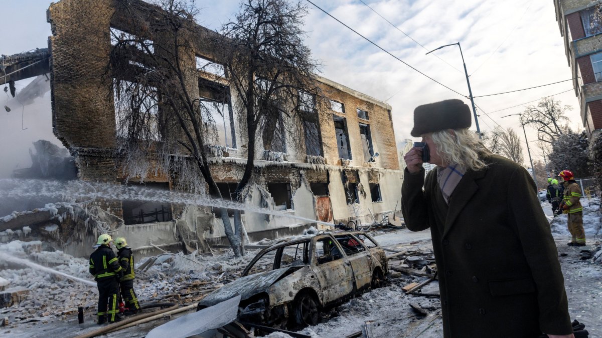 A man walks past a building that was hit by a Russian drone, amid Russia's attack on Ukraine, in Kyiv, Ukraine Jan. 12, 2026. (Reuters Photo)