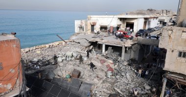 People inspect a destroyed building following an Israeli airstrike in an industrial area of Ghaziyeh, Sidon District, southern Lebanon, Jan. 6, 2026. (EPA Photo)
