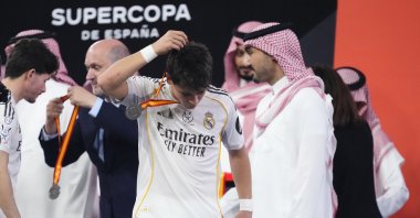 Real Madrid's Arda Güler (C) takes off his runners-up medal after losing to Barcelona during the Spanish Super Cup final at the King Abdullah Sports City Stadium, Jeddah, Saudi Arabia, Jan. 11, 2025. (AA Photo)
