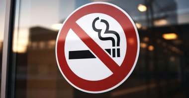 A no-smoking sign is displayed in a window. (Shutterstock Photo)