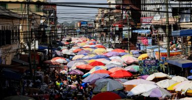 Stall umbrellas fill sections of a busy street at Makola market, Accra, Ghana, Dec. 6, 2025. (Reuters Photo)