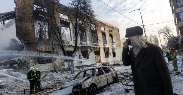 A man walks past a building that was hit by a Russian drone, amid Russia's attack on Ukraine, in Kyiv, Ukraine Jan. 12, 2026. (Reuters Photo)