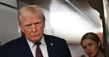 U.S. President Donald Trump speaks to the press aboard Air Force One, Jan. 11, 2026. (AFP Photo)