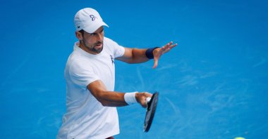 Serbia’s Novak Djokovic hits a forehand during a training session against Czechia's Jiri Lehecka in preparation for the Australian Open, Melbourne, Australia, Jan. 13, 2026. (AFP Photo)