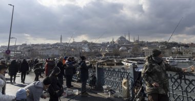 People use fishing rods on the Galata Bridge over the Golden Horn, Istanbul, Türkiye, Jan. 13, 2026. (EPA Photo)