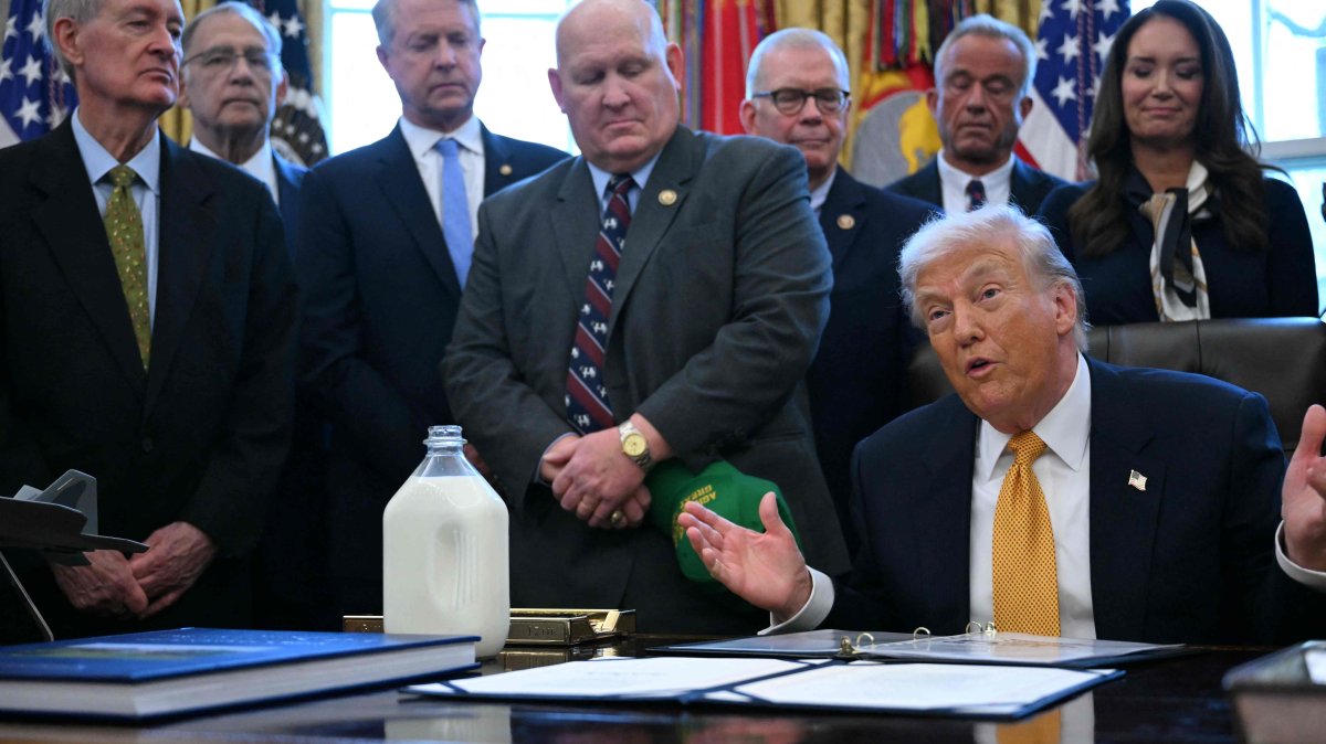 U.S. President Donald Trump jokes with attendees before signing bills in the Oval Office of the White House in Washington, D.C., Jan. 14, 2026. (AFP Photo)