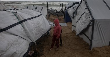Palestinians inspect their tents set up along the seashore west of Khan Younis amid heavy rainfall, southern Gaza Strip, Palestine, Jan. 13, 2026. (EPA Photo)