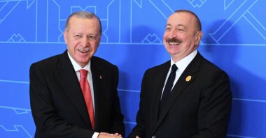 President Recep Tayyip Erdoğan (L) and Azerbaijani President Ilham Aliyev pose for a photo during the 17th summit of the Economic Cooperation Organization (ECO), Khankendi, Azerbaijan, Jul. 4, 2025. (AP Photo)