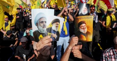 Hezbollah supporters hold images of late former Hezbollah leader Hassan Nasrallah and current leader Naim Qassem at a ceremony in Beirut, Lebanon, Sept. 27, 2025. (Reuters Photo)