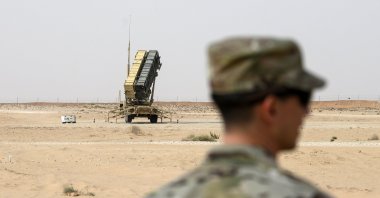 A member of the U.S. Air Force stands near a Patriot missile battery at Prince Sultan Air Base in Saudi Arabia, Feb. 20, 2020. (Pool via AP, File)