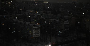 This aerial photograph shows a residential area on the left bank of the Dnipro River during a power outage in Kyiv, Jan. 13, 2026. (AFP Photo)