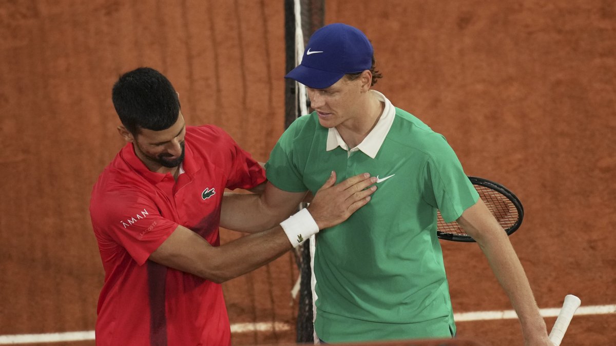 Winner Italy's Jannik Sinner (R) and Serbia's Novak Djokovic greet each other after their semifinal match of the French Tennis Open at the Roland-Garros stadium, Paris, France, June 6, 2025. (AP Photo)