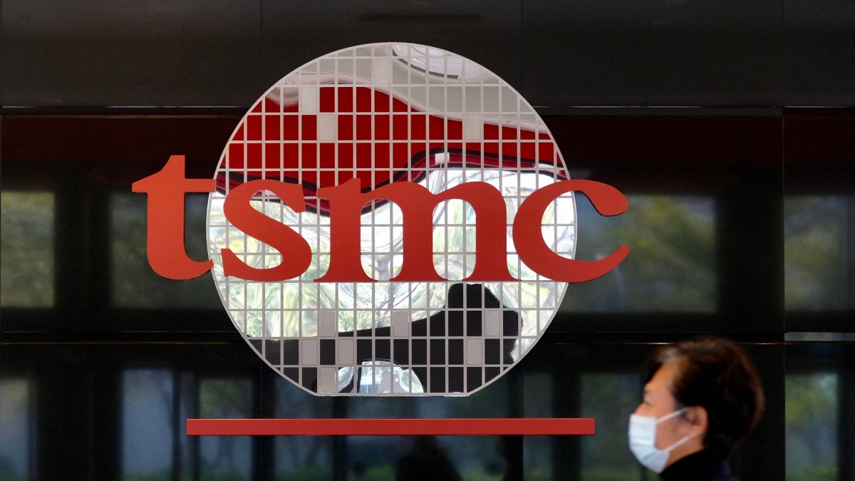 A man walks past a company logo at the headquarters of the world's largest semiconductor maker, TSMC, Hsinchu, Taiwan, Jan. 29, 2021. (AFP Photo)