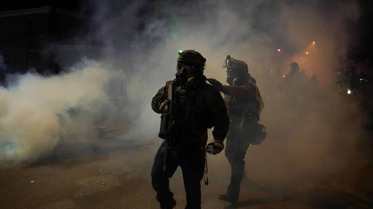 Law enforcement officers walk amid tear gas smoke, as tensions rise after federal law enforcement agents were involved in a shooting incident, a week after a U.S. Immigration and Customs Enforcement (ICE) agent fatally shot Renee Nicole Good, in Minneapolis, Minnesota, U.S., Jan. 14, 2026. (Reuters Photo)