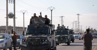 Syrian government military reinforcements arrive via the international M4 highway to the Deir Hafir area, Aleppo, Syria, Jan. 14, 2026. (AFP Photo) 