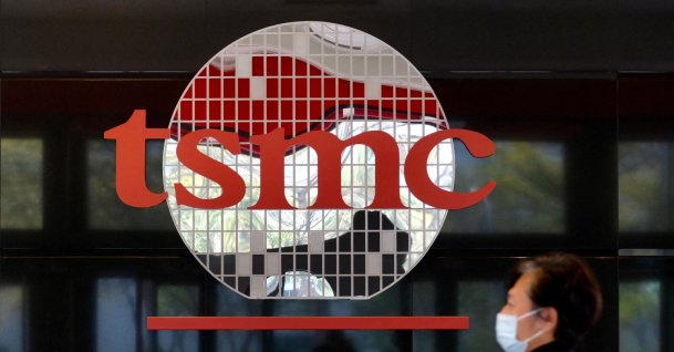 A man walks past a company logo at the headquarters of the world's largest semiconductor maker, TSMC, Hsinchu, Taiwan, Jan. 29, 2021. (AFP Photo)