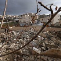 Relatives of Emran al-Atras, a Palestinian man who was killed in November, stand next to the rubble of his house after it was demolished by Israeli authorities in the Israeli-occupied West Bank city of Hebron, Jan. 15, 2026. (AFP Photo)