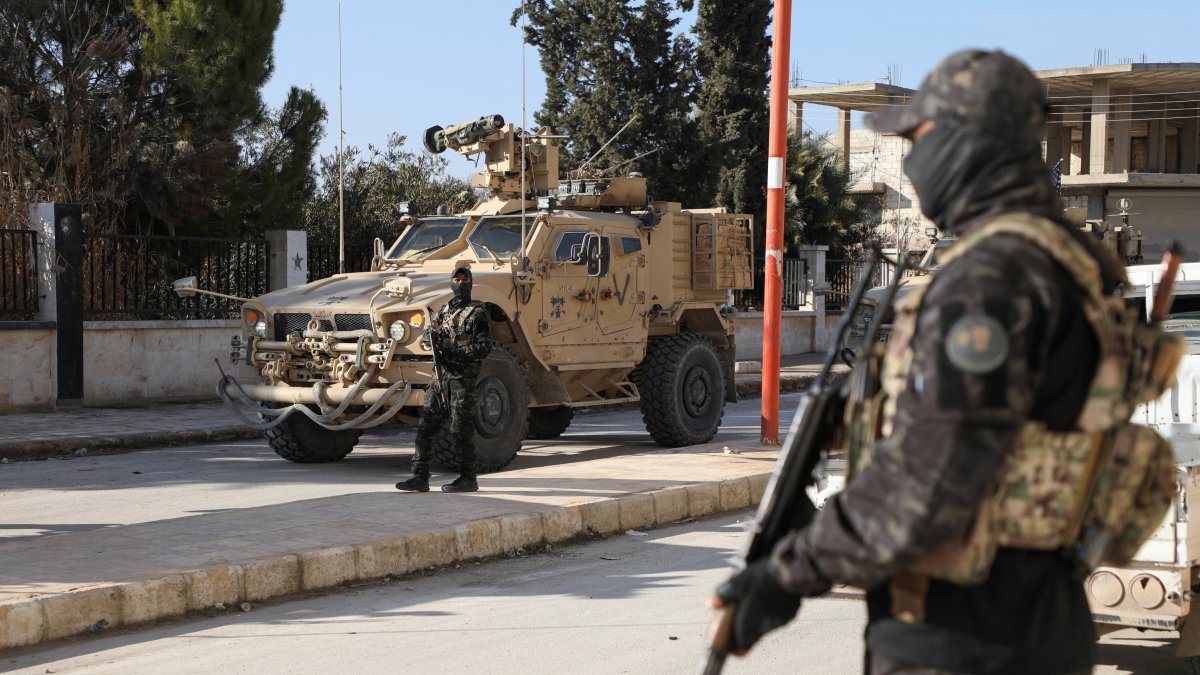 An SDF terrorist stands guard on the day of a meeting between with U.S. military leaders, in Deir Hafer, Syria. Jan. 16, 2026. (Reuters Photo)