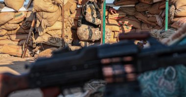 A member of the Syrian army monitors the frontline from a fortified military post in the Deir Hafer area, eastern Aleppo countryside, northern Syria, Jan. 16, 2026. (EPA Photo)