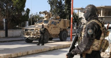 An SDF terrorist stands guard on the day of a meeting between with U.S. military leaders, in Deir Hafer, Syria. Jan. 16, 2026. (Reuters Photo)