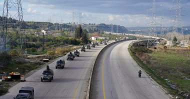 Military vehicles drive along a road as the last SDF militants left the Syrian city of Aleppo following a cease-fire deal that allowed evacuations after days of deadly clashes, in Latakia, Syria, Jan. 14, 2026. (Reuters Photo)
