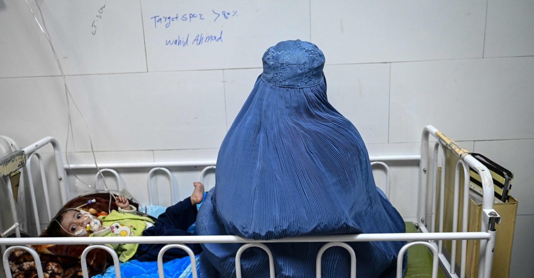 An Afghan woman sits next to her malnourished child inside the Medecins Sans Frontieres (MSF) therapeutic nutrition center at a hospital, Herat, Afghanistan, Jan. 8, 2026. (AFP Photo)