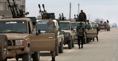 Syrian army soldiers along with their armoured vehicles gather as they prepare to enter the town of Deir Hafer, Aleppo, Syria, Jan. 17, 2026. (AFP Photo)