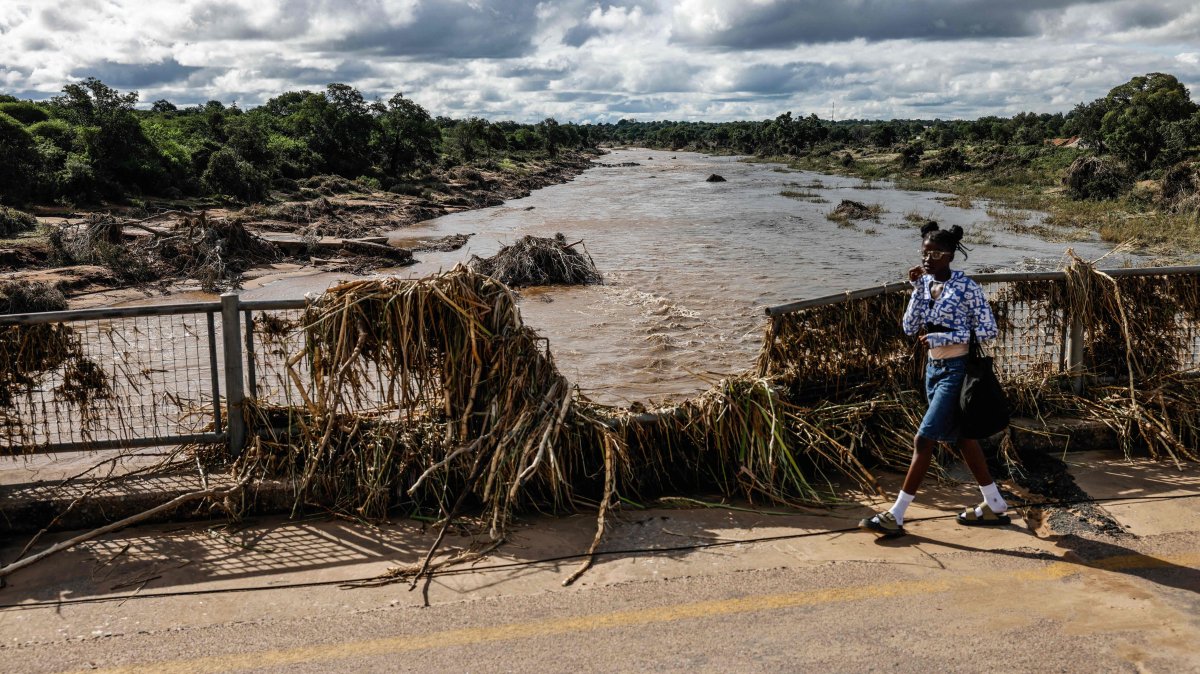A young girl walks across the damaged bridge crossing the Ga-Selati River, just outside Phalaborwa following heavy rains over much of the Limpopo Province, South Africa, Jan. 16, 2026. (AFP Photo)