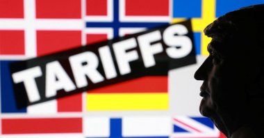 A 3D-printed miniature model of U.S. President Donald Trump and flags of eight European countries potentially facing U.S. tariffs is seen in this illustration taken created on Jan. 17, 2026. (Reuters Photo)