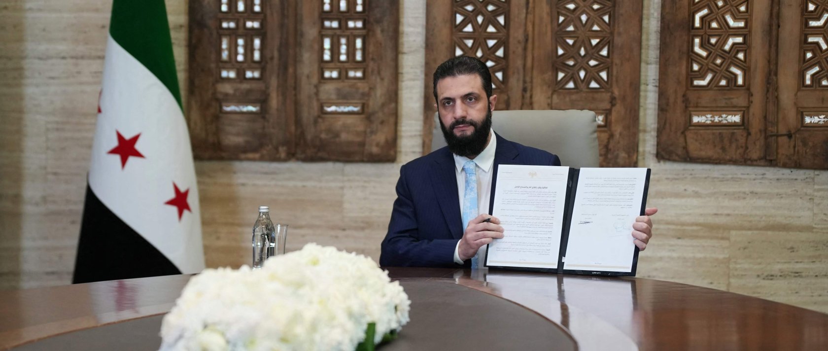 President Ahmed al-Sharaa signs an agreement at the Presidential Palace in Damascus, Syria, Jan. 18, 2026. (AFP Photo)