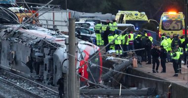 Members of the Spanish Civil Guard, along with other emergency personnel, work next to one of the trains involved in the accident, at the site of a deadly derailment of two high-speed trains near Adamuz, Cordoba, Spain, Jan. 19, 2026. (Reuters Photo)