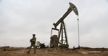 Syrian army forces stand at the Sevra oil field after taking control of the site from the YPG terrorist group in the rural area of Raqqa, Syria, Jan. 18, 2025. (AA Photo)