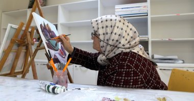 Esme Dalgıç, paints during an art class, continuing her lifelong learning journey in Çorum, Türkiye, Jan. 19, 2026. (AA Photo)
