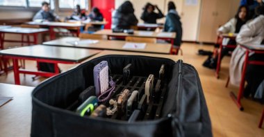 This photo shows a suitcase containing students' mobile phones, set aside during classes at the Jean Mermoz vocational high school in Montsoult, in the northern suburbs of Paris, France, Jan. 14, 2026. (AFP Photo)