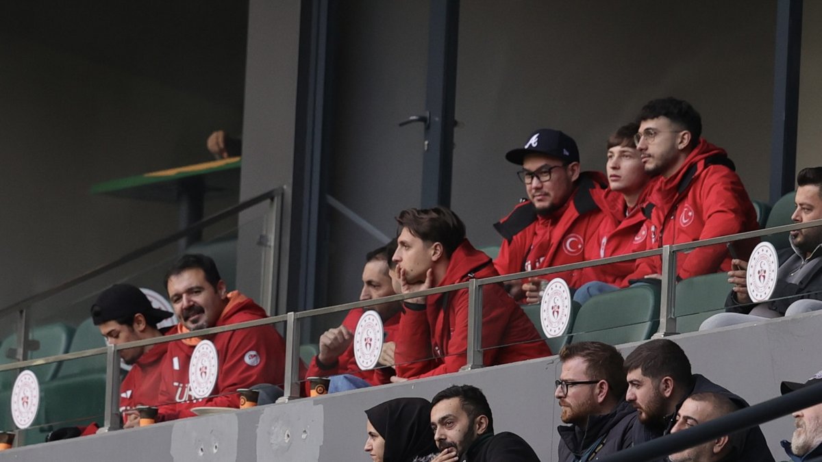 Short track Olympic hopefuls Furkan Akar (R) and Denis Örs (2nd R), part of Türkiye’s Milano-Cortina 2026 delegation, watch from the stands during the Turkish Cup match between Kocaelispor and Erzurumspor at Turka Araç Muayene Kocaeli Stadium, Kocaeli, Türkiye, Dec. 23, 2025. (AA Photo)