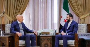 This handout picture released by the Syrian Presidency's Telegram page, shows Syria's President Ahmed al-Sharaa meeting with US envoy Tom Barrack at the Presidential Palace in Damascus, Jan. 18, 2026. (Photo by Handout / Syrian Presidency Telegram Page / AFP) 