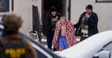 ChongLy Thao is detained after ICE agents conducted an immigration raid at his home, St. Paul, U.S., Jan. 18, 2026. (Reuters Photo)
