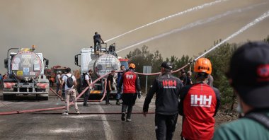 Humanitarian Relief Foundation (IHH) search and rescue teams work to control flames during a forest fire response operation in Türkiye, July 28, 2025. (AA Photo)